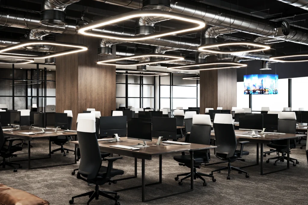 Contemporary open office workspace with modern desks, geometric lighting, and professional commercial interior design.