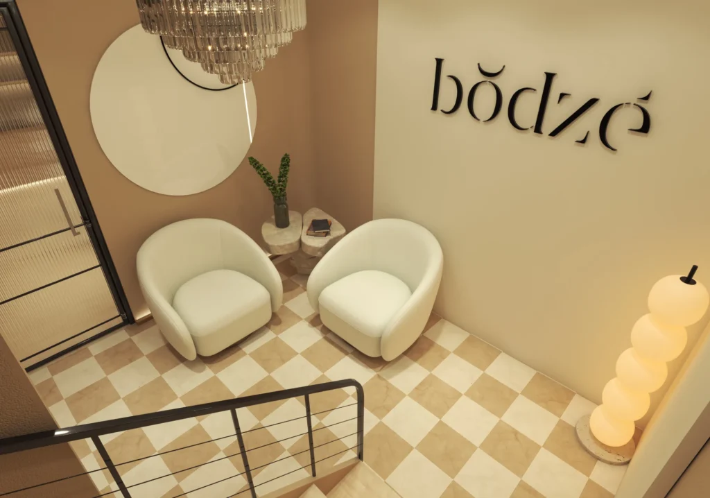 Contemporary spa waiting area with soft seating and decorative wall mirrors.