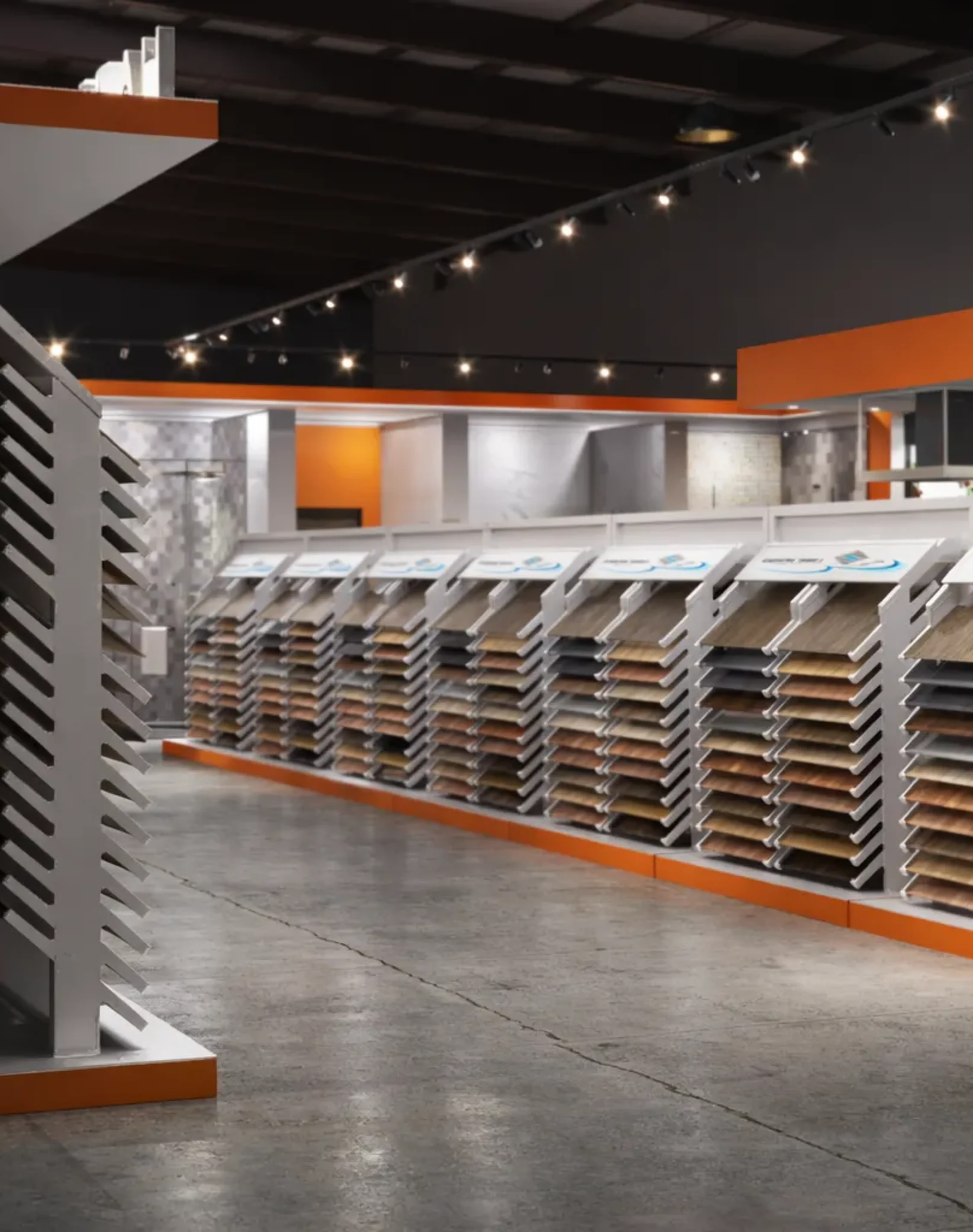 Spacious commercial tile gallery featuring modern flooring sample racks and sleek showroom layout.