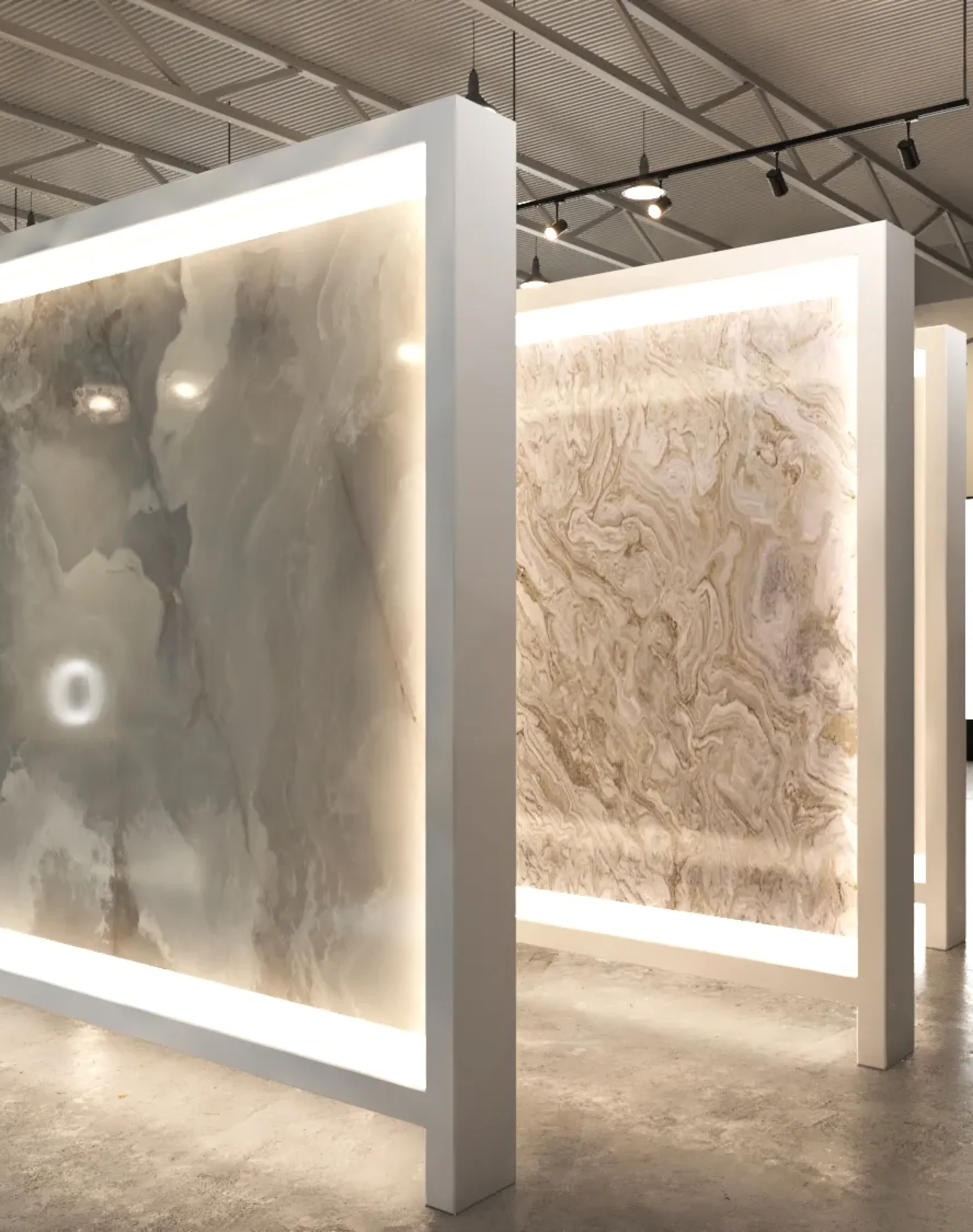Luxury marble slab showroom featuring illuminated backlit stone panels in a modern commercial interior.