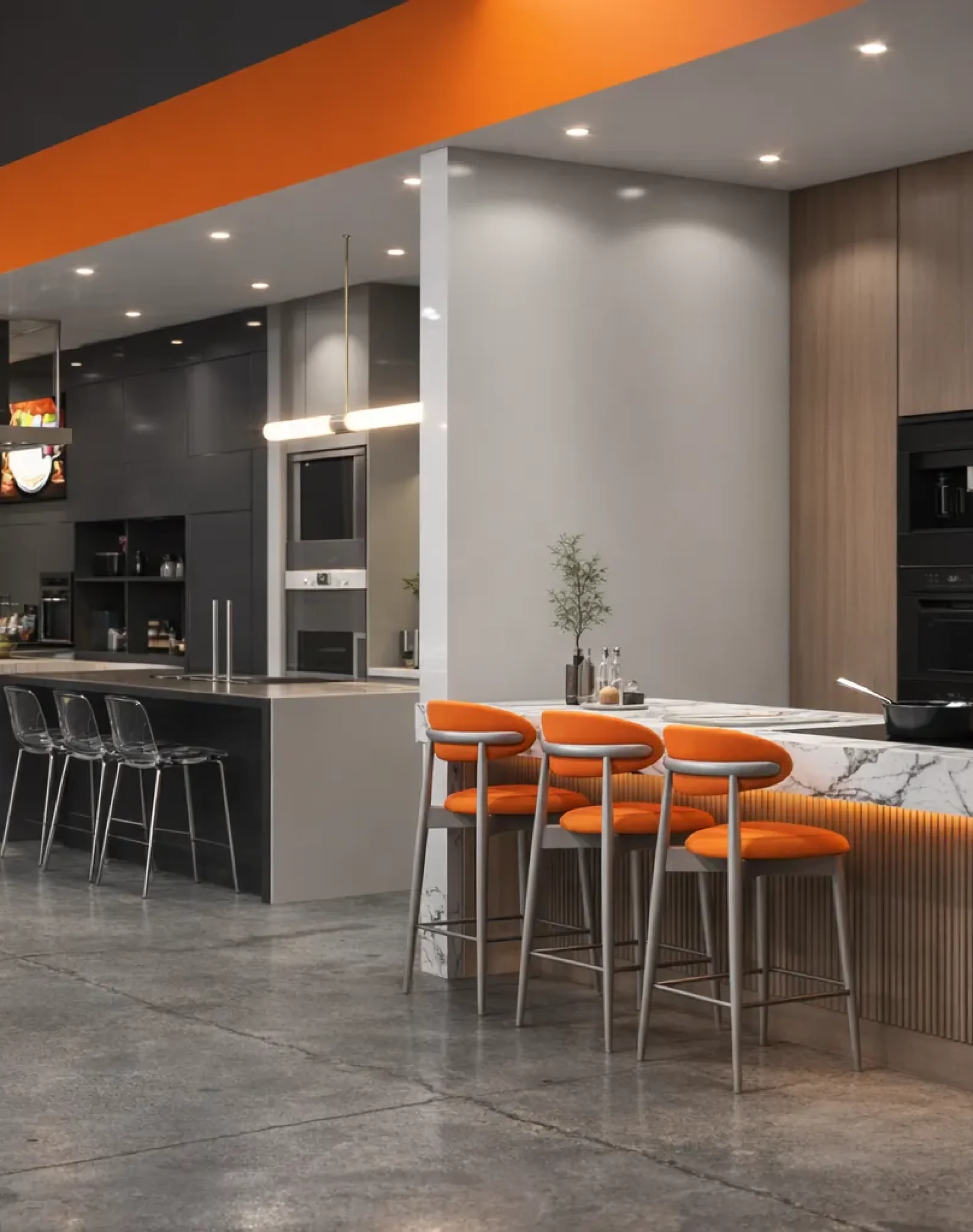 Contemporary kitchen showroom interior with luxury cabinetry, marble counters, and orange accent seating.
