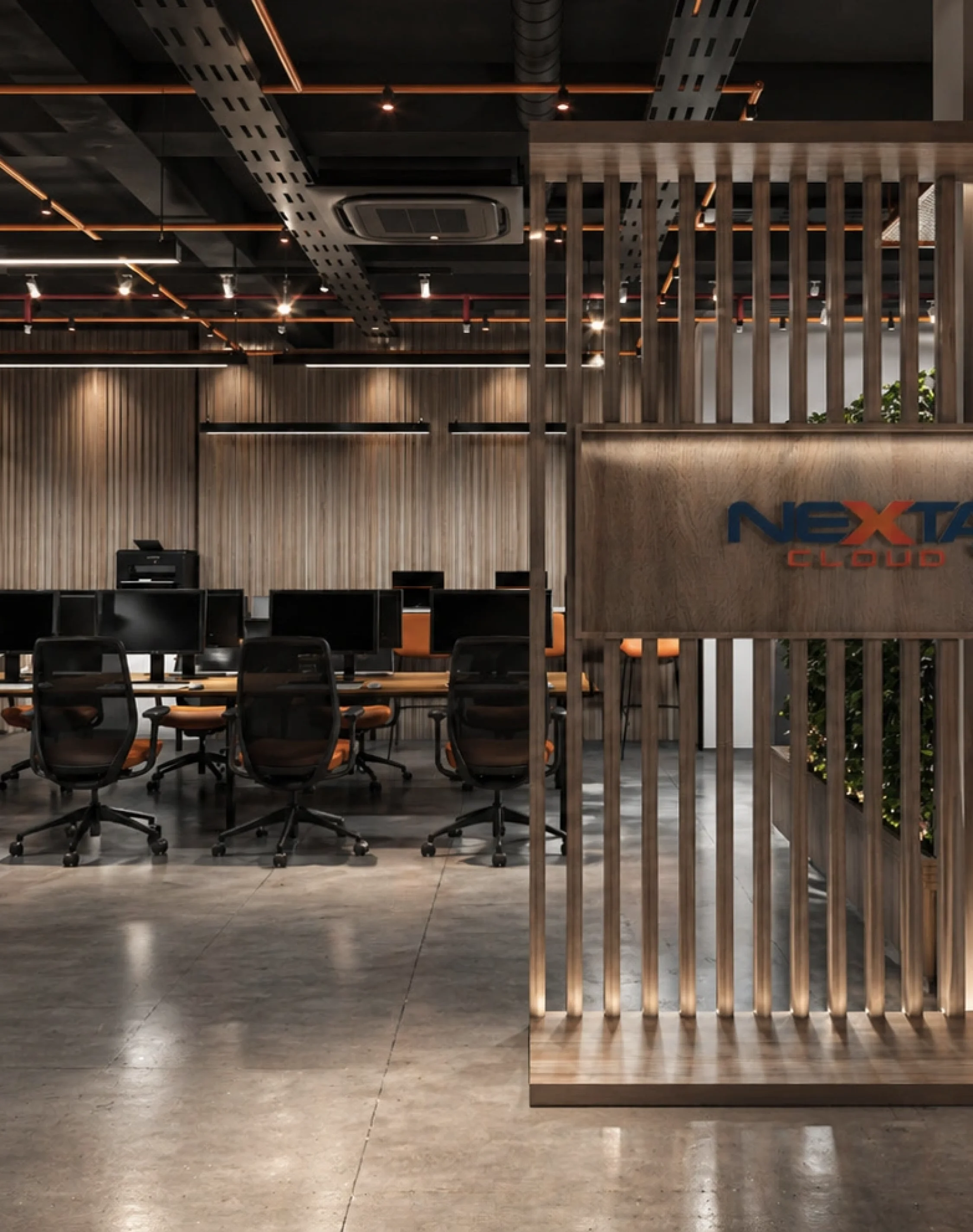 Contemporary tech office workspace with industrial interiors, branded partition walls, and collaborative workstation layout.